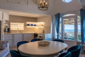 a kitchen and dining room with a table and chairs at Villa Costanza Amalfi Coast in Maiori