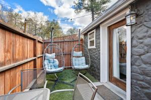 a patio with chairs and a fence at Modern Pet-Friendly Cottage - Graystone Retreat in Prescott +1 photo