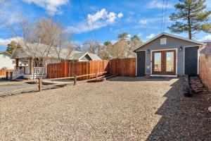 a home with a fence and a house at Modern Pet-Friendly Cottage - Graystone Retreat in Prescott