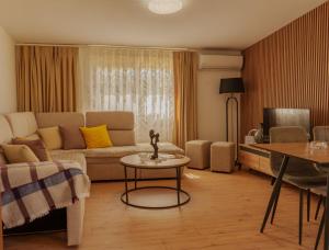 a living room with a couch and a table at Xhejn's Veranda 7 in Durrës