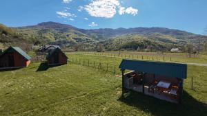 an aerial view of a farm with mountains in the background at Rest&peace homes in Mojkovac +45 photos