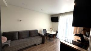a living room with a couch and a table at Kopa9 in Palanga