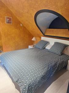 a bedroom with a large bed with a large mirror at Chambres à 10 min du circuit des 24h en campagne in Guécélard