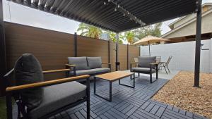 a patio with chairs and a table and a bench at Cozy Private Retreat in Phoenix