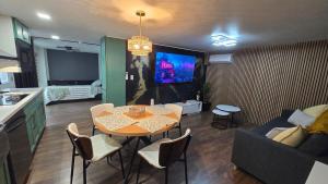 a kitchen and living room with a table and a couch at Cozy Private Retreat in Phoenix