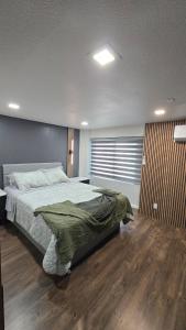 a bedroom with a large bed and a wooden floor at Cozy Private Retreat in Phoenix