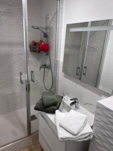 a white bathroom with a shower and a sink at Le Grain d Or in Blois +9 photos