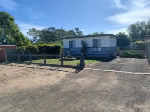 a house with a fence in front of it at Cozy Home Style Accommodation in Marong