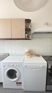 a white washer and dryer in a kitchen at Villa Fè -Choose Panoramic View, Jacuzzi, Private Parking in Montepulciano