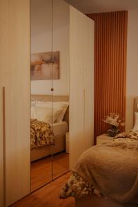 a bedroom with a mirrored closet and a bed at Xhejn's Veranda 7 in Durrës