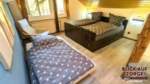 a small room with a bed and a couch at Arode Lodge Blick auf Zorge - Mountain Lodge with Panoramic Views in Zorge