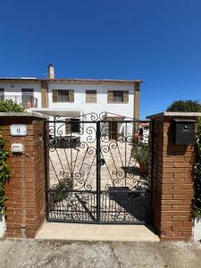 an iron gate in front of a building at Il Quinto senso di Lù in Capalbio