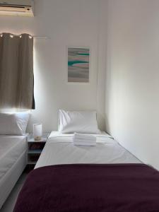 a bedroom with a bed and a painting on the wall at Professor Guest House in Santo Amaro +35 photos