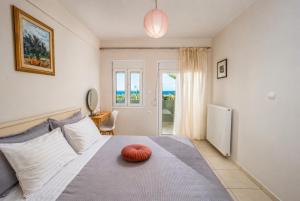 a bedroom with a bed with a red pillow on it at 4 Seasons villa-Sea view in Hersonissos