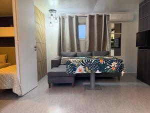 a bedroom with a couch and a bed in a room at Mobil Home La Barrosa in Chiclana de la Frontera