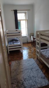 a room with two bunk beds and a window at Hostel Latin Bridge in Sarajevo +12 photos