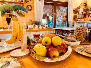 a bowl of fruit on a table with bananas and pears at Oasi Muru Idda in Budoni