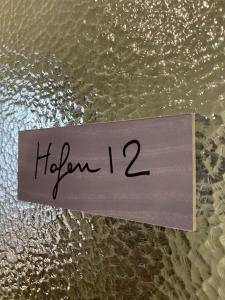 a sign with the word hiden on top of water at Hafen12 in Bremerhaven