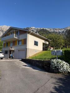 a house with a car parked in front of it at Mountain and Lake in Bönigen