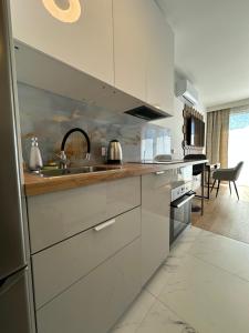 a kitchen with a sink and a counter top at LUXURY Portovo in Gdańsk