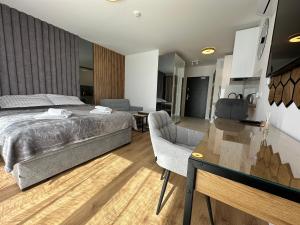 a bedroom with a bed and a desk and a table sidx sidx sidx at LUXURY Portovo in Gdańsk +10 photos