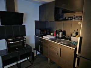 a small kitchen with a sink and a microwave at Boutique apartment in Strömstad in Strömstad +7 photos