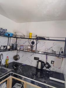 a kitchen with a counter top with some dishes on it at Tamraght samba 3 in Tamraght Ou Fella