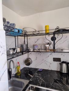 a kitchen with a sink and a counter top at Tamraght samba 3 in Tamraght Ou Fella