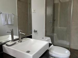 a bathroom with a sink and a toilet and a shower at Posada Tierra Viva - Villa de Leyva in Villa de Leyva +39 photos