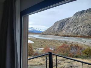a view from a window of a river and mountains at Panorama Aparts Chalten in El Chalten