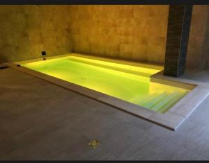a swimming pool in a room with at Nice Wellness Apartman in Siófok