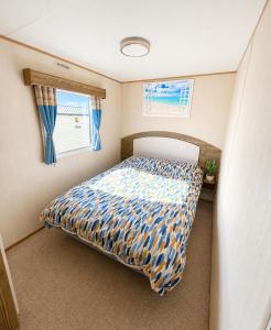 a bedroom with a bed in a small room at Golden Sands Getaways Weymouth in Wyke Regis +20 photos