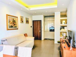 a living room with a couch and a tv at The Twins Suite & Hub in Monza