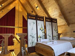 a bedroom with a bed in a wooden house at Bondo'S Cottage in Kobuleti