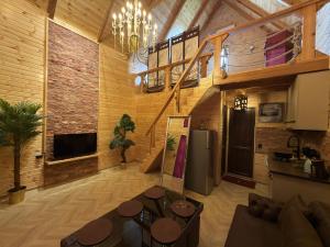 a living room with a refrigerator and a table at Bondo'S Cottage in Kobuleti