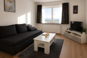 a living room with a couch and a coffee table at Apollo Home - Im Zentrum der Natur in Wildflecken