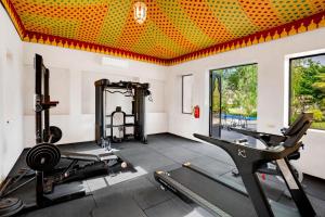 a gym with treadmills and exercise equipment in a room at Palais Nouhass in Marrakesh