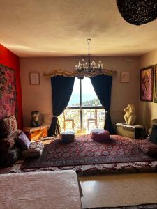 a bedroom with a large bed with a large window at Mandala Chai Studios in Mellieħa