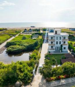 a view of a building and the beach at KuneVain Guest House in Lezhë