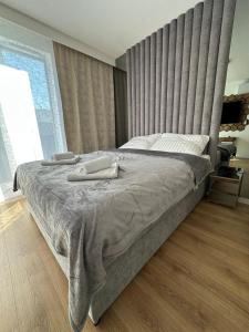 a bedroom with a large bed with a large headboard at LUXURY Portovo in Gdańsk