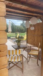 a patio with a table and a chair and an umbrella at Chalet Le Luc - Casa Zenitude in Le Luc