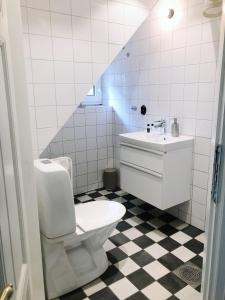 a bathroom with a toilet and a sink at Farmors Lycka in Kivik