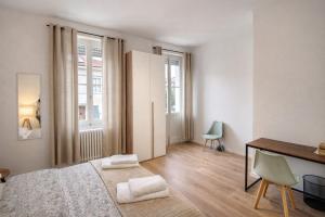 a white room with a bed and a desk and a table at Affittacamere Villa Soria in Pesaro +30 photos