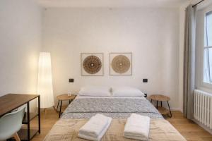 a bedroom with a bed and a desk and a window at Affittacamere Villa Soria in Pesaro