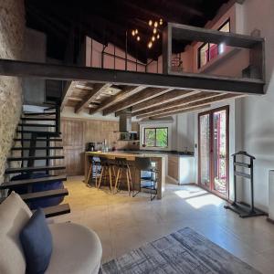 a living room with a loft bed and a kitchen at Hotel Pietro Santo ValQuirico in Santeagueda