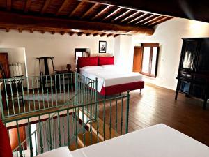 a bedroom with a bed and a staircase in a room at La Casa di Nonna Iolanda in Gualdo Cattaneo