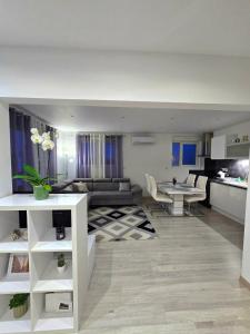 a living room with a couch and a table at DIAG Appartement 3 Chambres in Commequiers