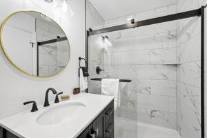 a white bathroom with a sink and a mirror at Fresh Coast Motel in Fish Creek +52 photos