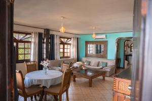 a living room with a table and a couch at Host Company Jaco Luxury in Jacó