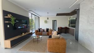 a living room with two couches and a tv at VnA Executive Suites in Pretoria